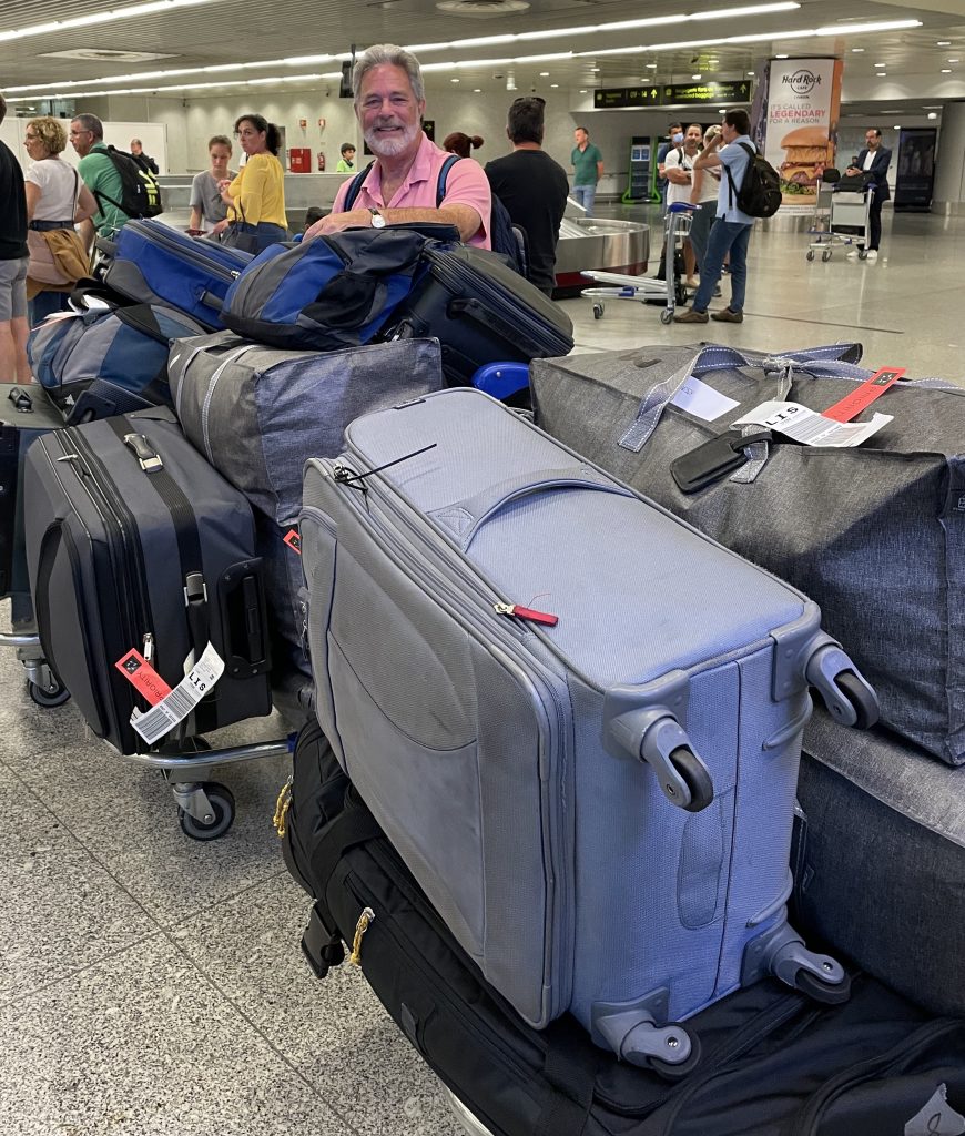 multiple bags of luggage in airport arrival area